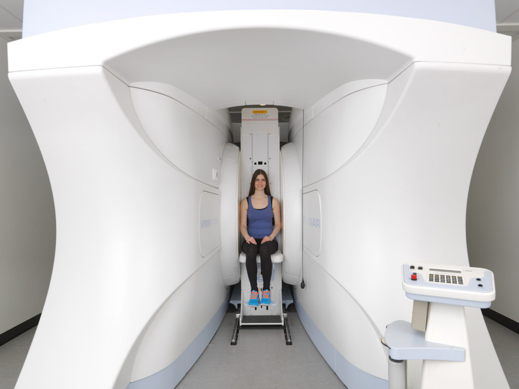 Woman in Medserena Upright Open MRI scanner